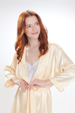 nice girl in beige home dressing gown clipart