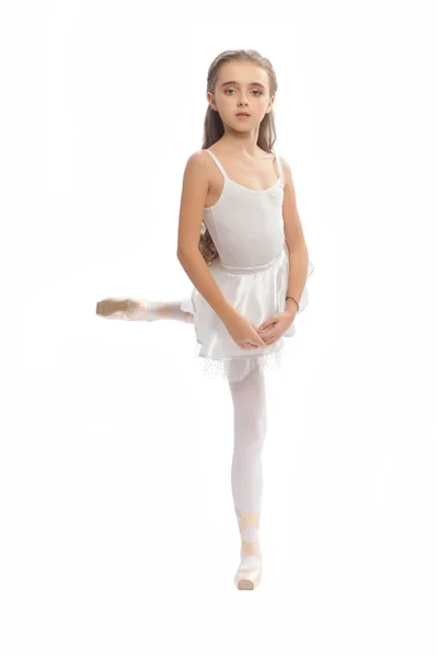 Young girl in her dance clothes reaching down to touch her foot. — Stock Photo, Image