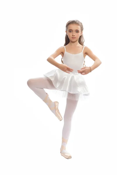 Young girl in her dance clothes reaching down to touch her foot. — Stock Photo, Image