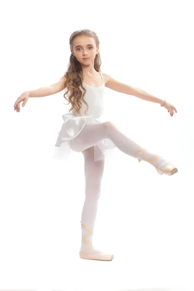 Young girl in her dance clothes reaching down to touch her foot. — Stock Photo, Image