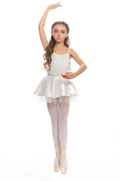 Young girl in her dance clothes reaching down to touch her foot. — Stock Photo, Image