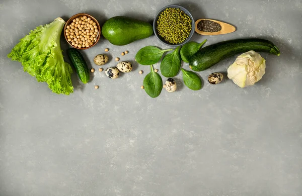 Vegetables and greens on a gray background. Template for creating a list of products for a healthy diet or menu.