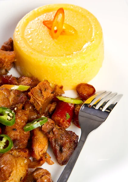 Pork sausage and meat stew with polenta — Stock Photo, Image