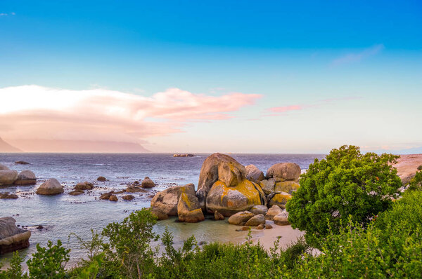 Boulders is a turqoise rocky and sheltered beach in cape town South Africa taken as sunset