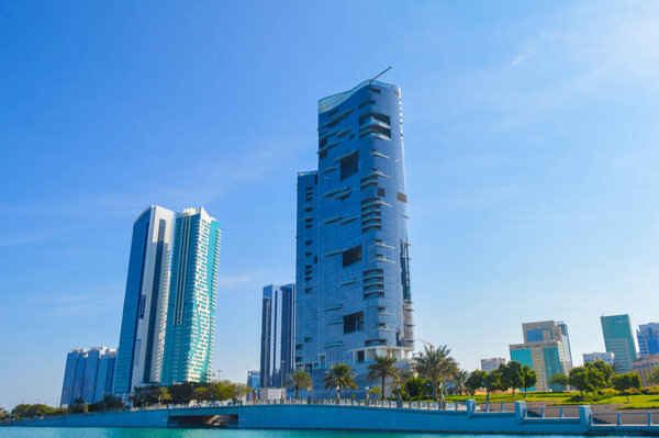 Abu Dhabi capital of united arab emirates skyline along Corniche beach taken from a boat