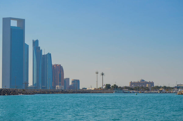 Abu Dhabi capital of united arab emirates skyline along Corniche beach taken from a boat