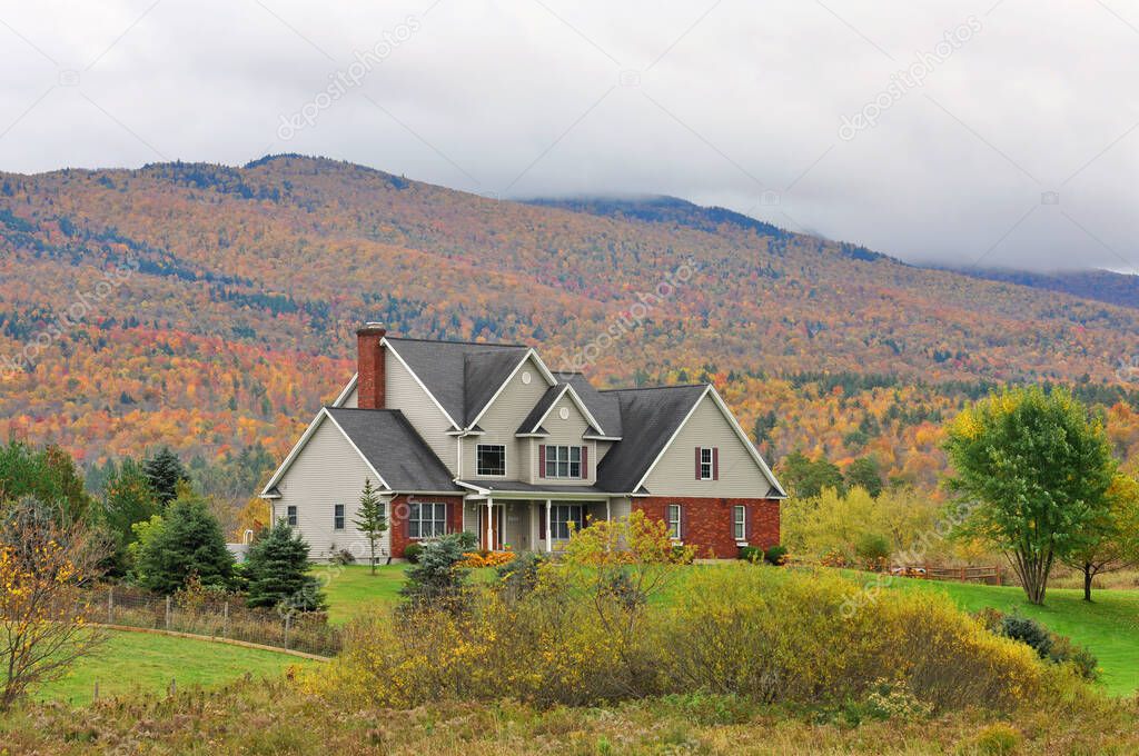 Vermont Fall Foliage in a cloudy day, Mount Mansfield in the background, Vermont VT, USA.