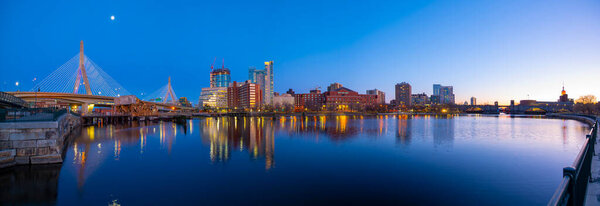 Boston Leonard P. Zakim Bunker Hill Memorial Bridge and Charles River panorama at night with twilight, Boston, Massachusetts MA, USA.