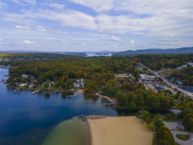 Lake Winnipesaukee and village of Weirs Beach aerial view with fall foliage in City of Laconia, New Hampshire NH, USA.  clipart