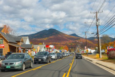 Lincoln Main Caddesi şehir merkezinde ve Little Coolidge Dağı Kancamagus Highway arka planda sonbahar yeşillikleri ile, Lincoln Town, New Hampshire NH, ABD.