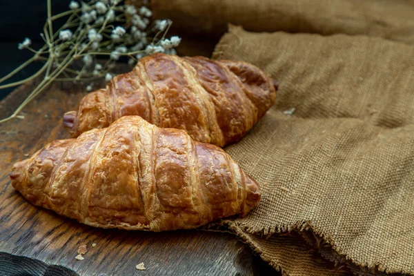美味的新鲜羊角面包放在准备吃的木制盘子上 一个美味的法国早餐 从顶部斜视 案文的位置 — 图库照片