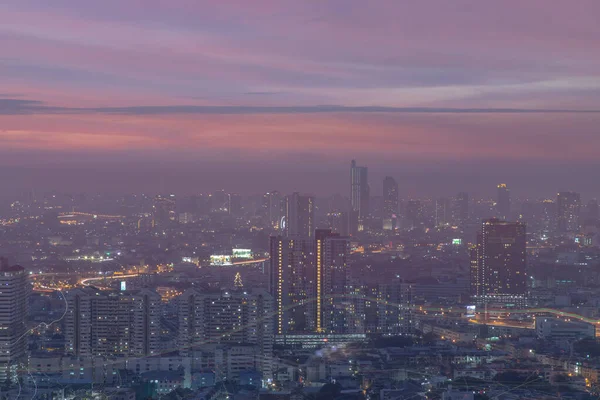 Bangkok, thailand - Dec 23, 2020 : Looking through the window mirror to see The cityscape of Bangkok with skyscrapers and bright glowing lights at night. Focus and blur.