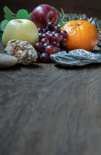 Variety of fresh assorted fruits on the old wooden table. Assorted fruits colorful background, healthy fruits, Dark tone, Copy space, Selective focus.