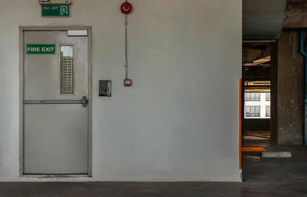 Fire exit door for emergency case with alarm for safety protection of the car parking  building near the Condominium building. Safety first concept, Copy space, Selective focus.