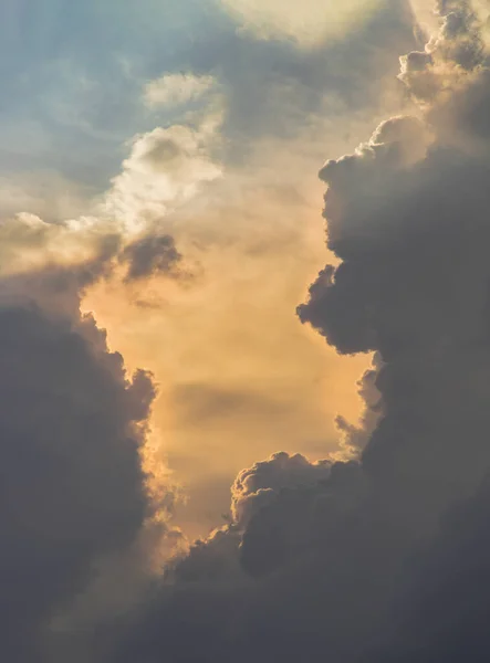 The sun shines through the clouds in the sky.  The shape of the clouds evokes imagination and creativity. They can be used as wallpapers that look amazing. Copy space, No focus, specifically.