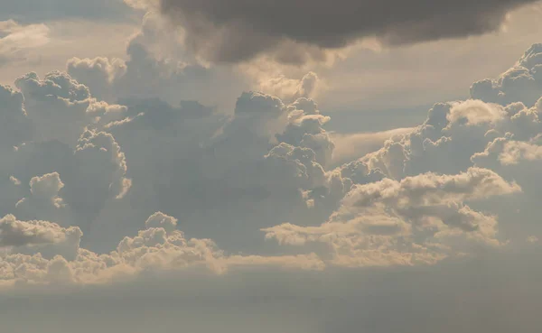 The sun shines through the clouds in the sky.  The shape of the clouds evokes imagination and creativity. They can be used as wallpapers that look amazing. Copy space, No focus, specifically.