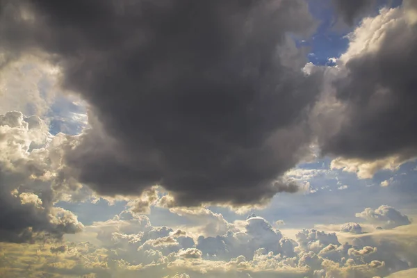 The sun shines through the clouds in the sky.  The shape of the clouds evokes imagination and creativity. They can be used as wallpapers that look amazing. Copy space, No focus, specifically.