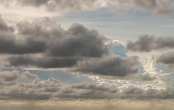 The sun shines through the clouds in the sky.  The shape of the clouds evokes imagination and creativity. They can be used as wallpapers that look amazing. Copy space, No focus, specifically.