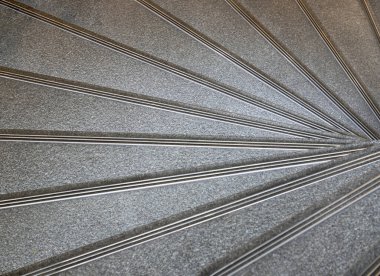 The geometric shape of the staircase winds in a spiral pattern. Looking down view of helix stairs, Interesting architectural elements of Layered stone spiral stairs, use it as your Wallpaper, Poster and Space for text, Selective focus.