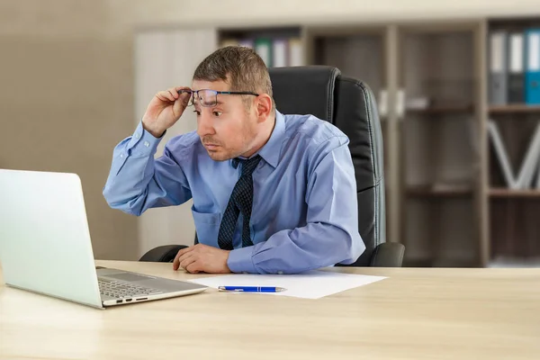 Baas Zakenman Aan Zijn Bureau Kijkt Verbaasd Naar Laptop Heft — Stockfoto