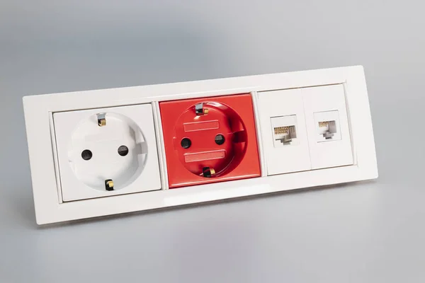 A block of electrical outlets and a network outlet on a gray background. Home electrician. Close-up. Full focus. copy space