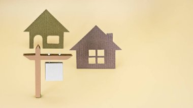Konut kredisi, satış ve kiralık konut ve emlak kavramı. Evlerin maketlerinin arka planında satışı ya da kiralanması ile ilgili duyuru. Uzayı kopyala Model