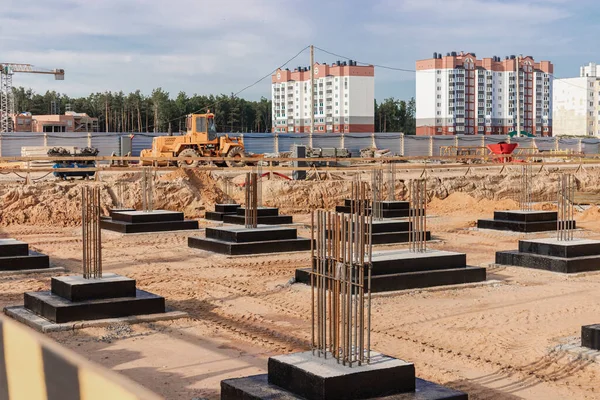 Monolithic reinforced concrete foundations for the construction of a residential building. Grillage at the construction site. Construction pit with foundations