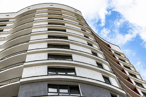 Multi-storey modern residential building against the blue sky. Housing construction. Residential fund. Sleeping residential area. Mortgage loans for young families