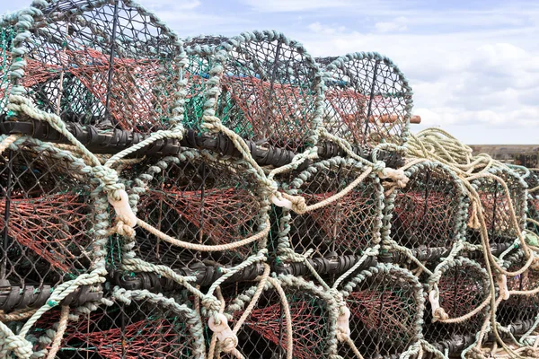 Lobster or crab pots stacked on jetty — Stock Photo, Image