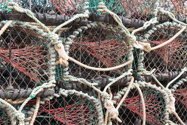 Lobster or crab pots stacked on jetty — Stock Photo, Image