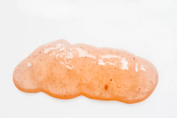Blob di scrub corpo arancione su bianco Foto Stock