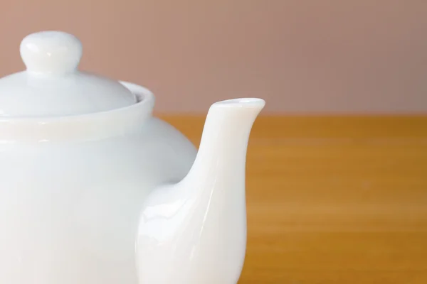 White teapot on a wooden table — Stock Photo, Image