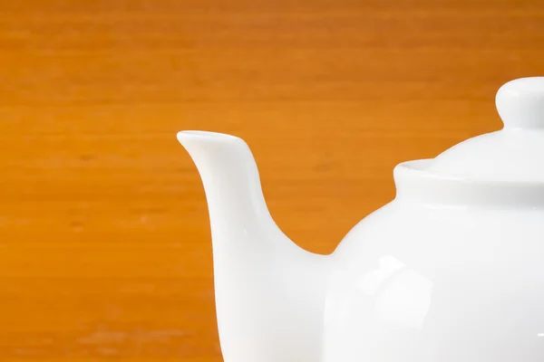 Close up white teapot on wooden table — Stock Photo, Image