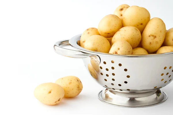 New potatoes in a stainless steel colander — Stock Photo, Image