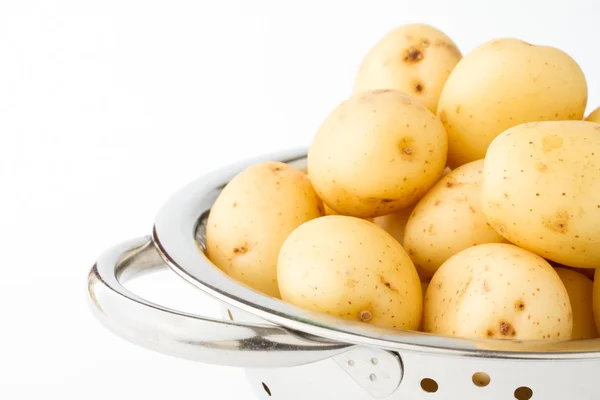 New potatoes in a stainless steel colander — Stock Photo, Image