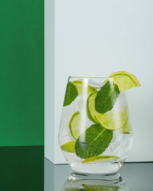 Renkli arkaplanda bir bardak ferahlatıcı kokteyl