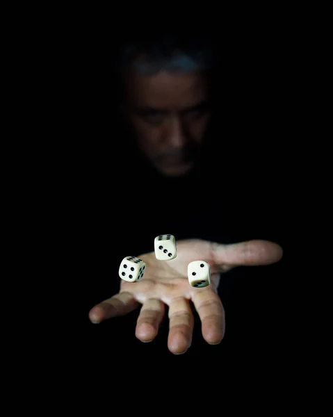 White dice cubes on black background, playing dice in casino