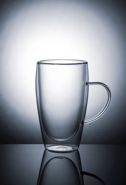 Glass tumbler on gradient background