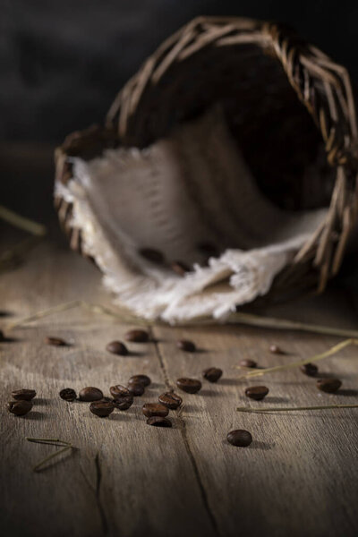 Scattered roasted coffee beans on rustic table