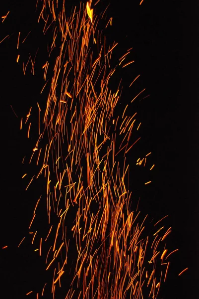 Fire sparks and red flame sparkles on black background — Stock Photo, Image