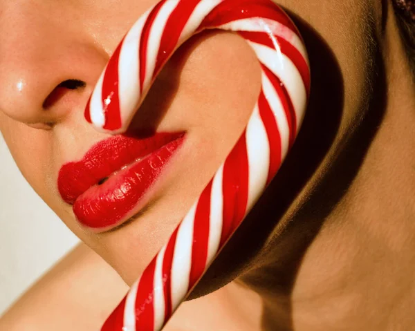 Woman with christmas striped candy stick — Stock Photo, Image