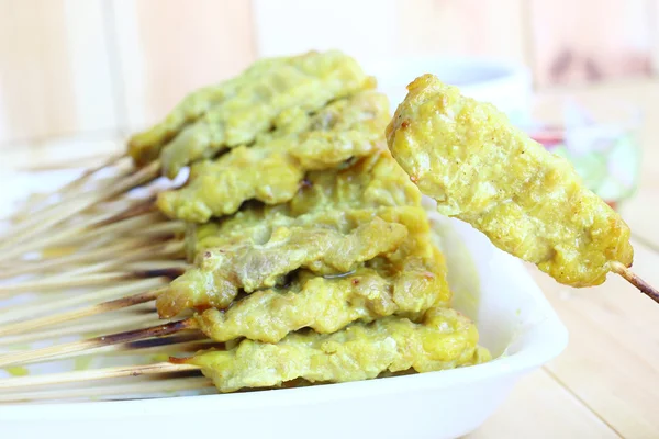 Domuz eti satay göstermek için el. Domuz eti satay isthai mutfağı gıda