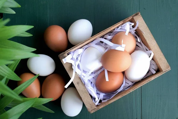 yellow and white eggs in a wooden box