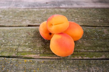 Ahşap arka planda taze ve olgun kayısı kavramı