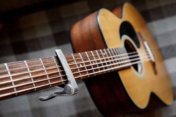 Acoustic guitar neck with a capo — Stok Foto