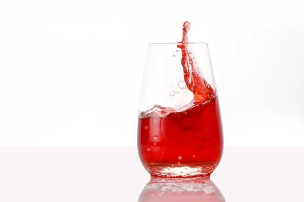 Red juice splashes on isolated white background