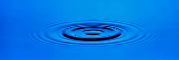 The circle ripple of the surface of the blue water. — Stock Photo, Image