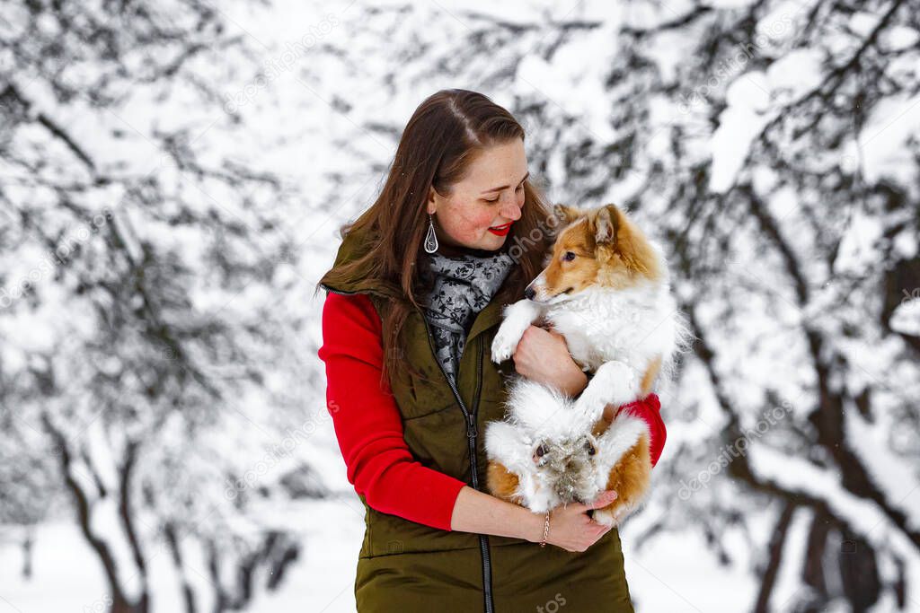 Girl with her dog in winter park