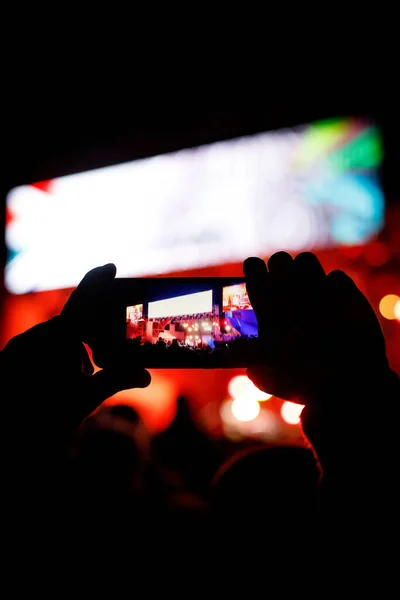 Silhouette of using a mobile phone at a concert