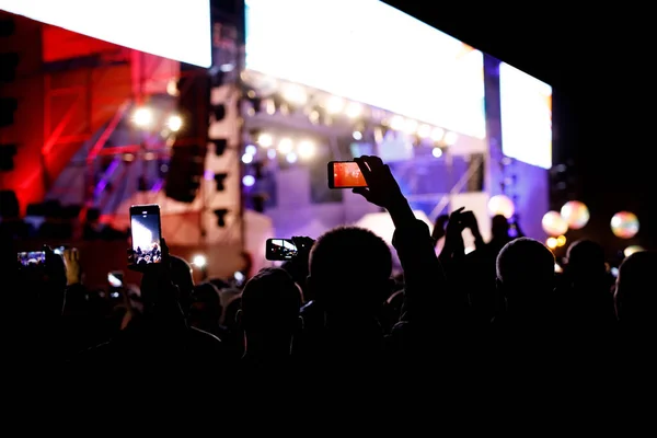 Silhouette of using a mobile phone at a concert